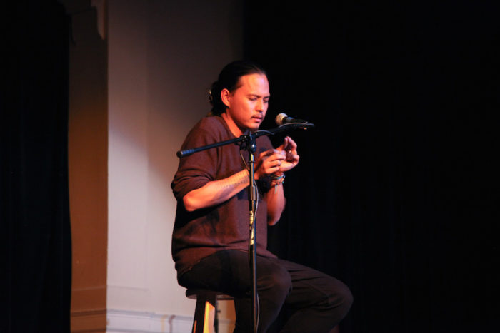 Roldy Ablao onstage at the Rainier Arts Center for the Seattle Globalist's "Stories of Finding Home." (Photo by Alex Stonehill.)