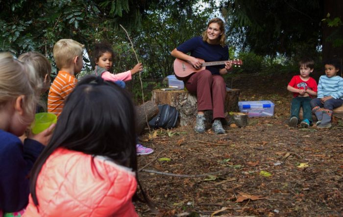 Rachel Franz, lead teacher at Tiny Trees sings to her students. The new outdoor daycare inspired by Scandinavian models claims to provide much more affordable daycare options especially in diverse and low income neighborhoods. (Photo by Ellen Banner / The Seattle Times)