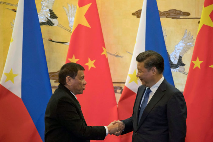 Philippine President Rodrigo Duterte (L) and Chinese President Xi Jinping shake hands after a signing ceremony held in Beijing, China October 20, 2016. (Photo by Ng Han Guan for Reuters/Pool)