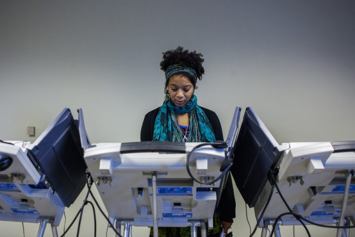 Natassha Chavis, a first-time voter, fills in her ballot on November 8, 2016 at the King County Department of Elections in Renton, WA. Chavis said she’s voting to set an example for her children. (Photo by Jovelle Tamayo)