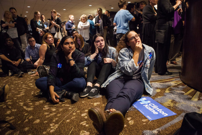 (L-R) University of Washington students Madhavi Kuthanur, Melissa Diamond and Olivia Corti react as polling results move in the favor of Republican Presidential nominee, Donald Trump. (Photo by Jovelle Tamayo.)