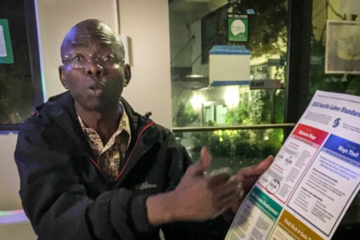 Felix Ngoussou, a Seattle Central District business owner and an immigrant from Chad, supports Initiative 1433, but acknowledges the initiative puts a burden on small businesses. (Photo by Lee Nacozy.)