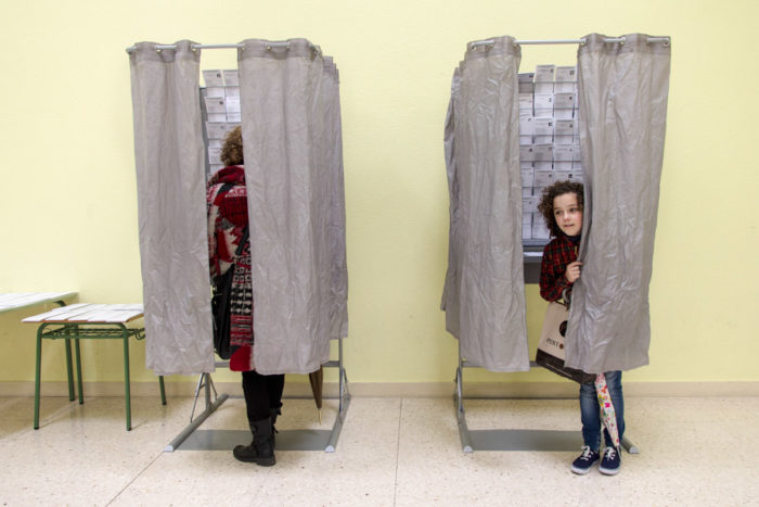 A girl goes with her mother to vote for the European Parliament elections in 2014. Most young Europeans we asked said they're watching the U.S. election closely and that it will directly impact their lives. (Photo from Flickr by Enrique Balenzategui Arbizu)