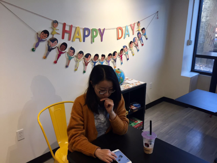 Yanqing Lou is looking for a new recipe on her favorite cooking app while drinking milk tea. (Photo by Xinyi Xiong)