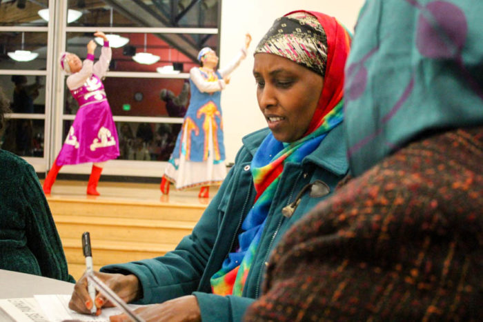 Habiba Hussein of Seattle votes at a multilingual ballot party at New Holly Gathering Hall on Friday evening. (Photo by Venice Buhain)