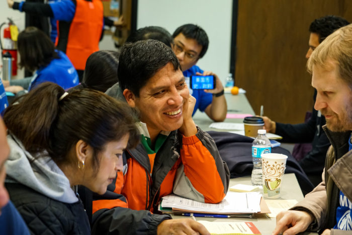 A family talks with a volunteer about any potential red flags regarding their citizenship application at a 2016 citizenship workshop held by the Seattle Office of Immigrant and Refugee Affairs. (Photo by Alabastro Photography)