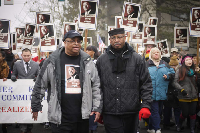 King County Councilmember Larry Gossett and Civil Rights Activist Tony Orange at the head of the march in 2013. (Photo by Susan Fried)