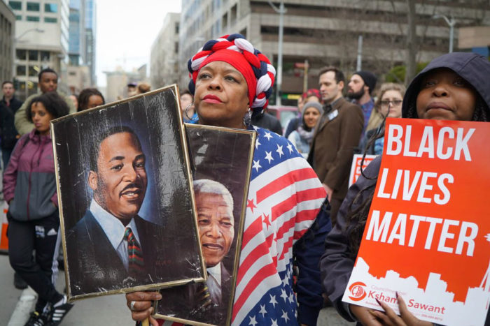 Fai Mathews was back again in 2016 with her pictures of MLK and Mandela, alongside a Black Lives Matter sign. (Photo by Susan Fried)