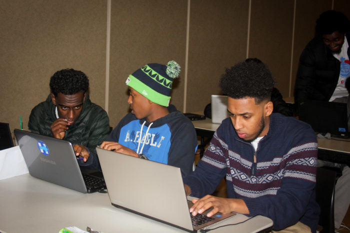 Awol Ibrahim (center) and Dursa Mohammed (right) bridged from Companion Athletics sports programs into the coding classes. (Photo by Goorish Wibneh)