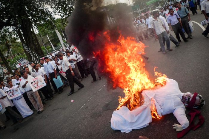Demonstrators at the funeral of Lasantha Wickrematunge, an assassinated Sri Lankan journalist, burn an effigy of the Sri Lankan President Mahinda Rajapaksa in 2009. (Photo by Indi Samarajiva)