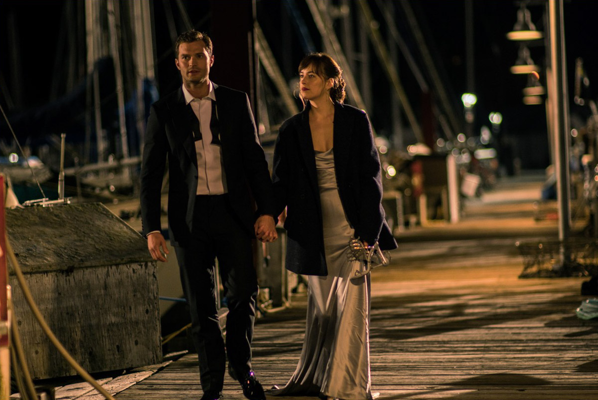Jamie Dornan and Dakota Johnson take a moonlight walk on a Seattle dock in "50 Shades Darker." Most of the film was actually shot in Vancouver, where film incentives make it much cheaper. (Photo by Doane Gregory/Universal Pictures)