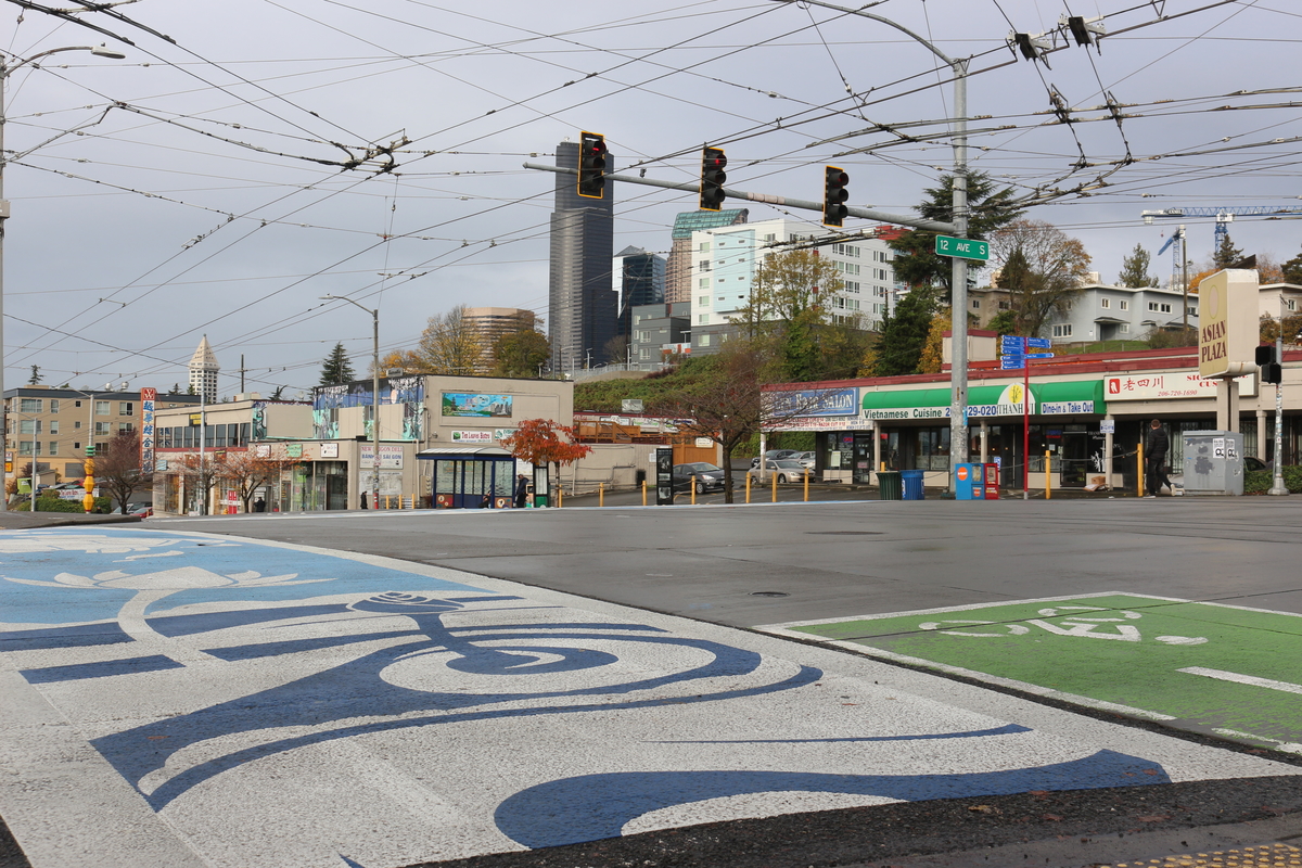 A new mural painted on the crosswalks of 12th and Jackson in July 2017 looks onto the Seattle skyline. The crosswalk sits at the entrance of Little Saigon and represents many aspects of Vietnamese culture.